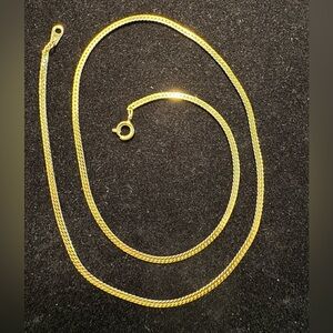 Gold-tone 17" herringbone chain necklace.